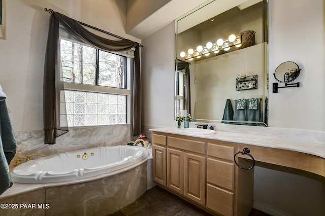 full bathroom featuring a garden tub and vanity