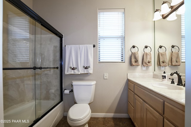 bathroom with tile patterned flooring, baseboards, bath / shower combo with glass door, toilet, and vanity