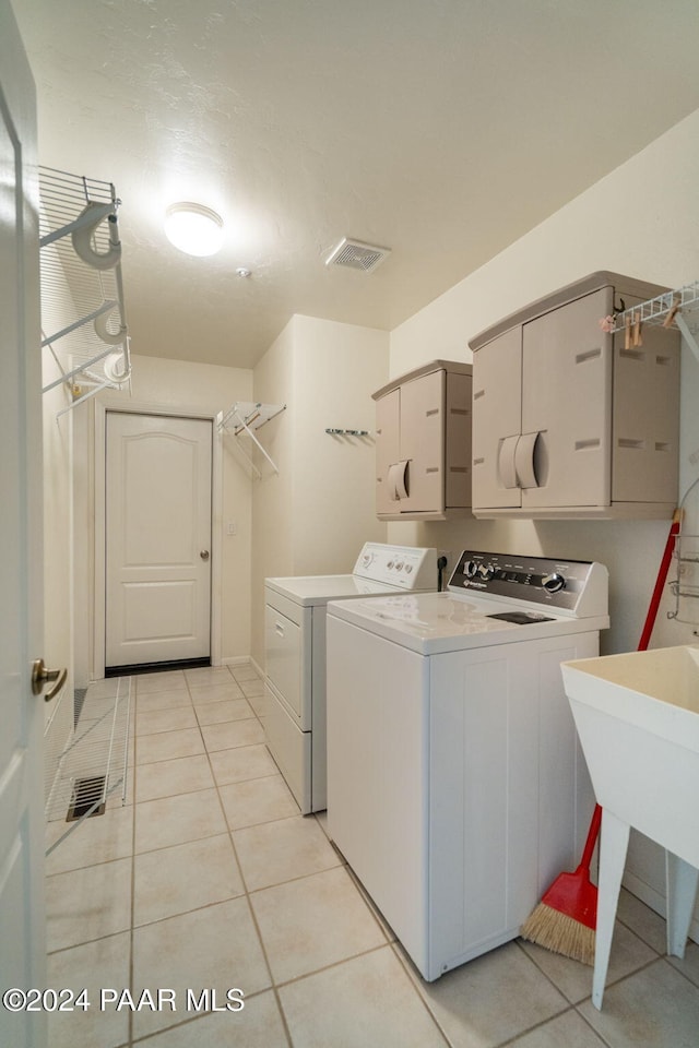 washroom featuring separate washer and dryer and light tile patterned flooring