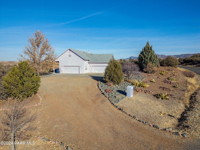 view of front facade with a mountain view and a garage