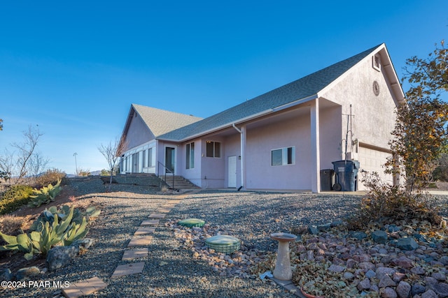 view of side of home featuring a garage