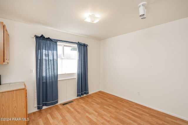 spare room with hardwood / wood-style floors