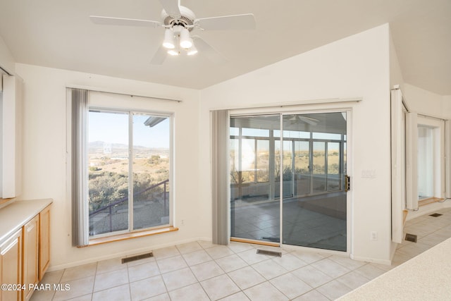 tiled empty room with ceiling fan and lofted ceiling