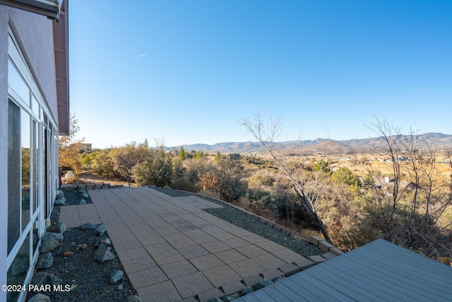 exterior space with a mountain view and a patio