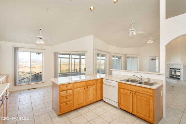 kitchen featuring dishwasher, light tile patterned flooring, lofted ceiling, and sink