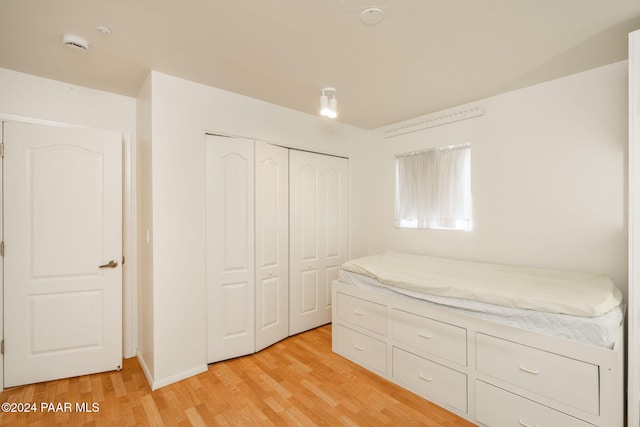 unfurnished bedroom with a closet and light hardwood / wood-style flooring