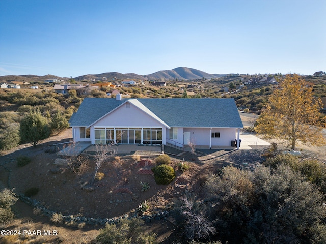 back of property with a mountain view