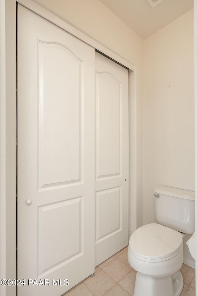 bathroom featuring tile patterned flooring and toilet