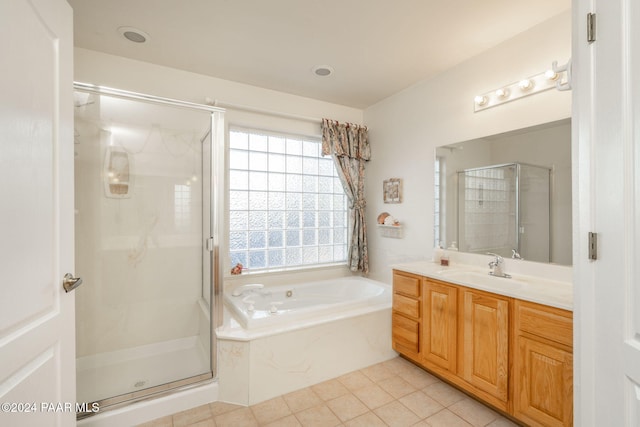 bathroom with tile patterned floors, vanity, and independent shower and bath