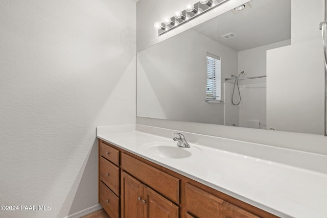 bathroom with vanity and walk in shower