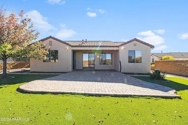 rear view of property with a lawn