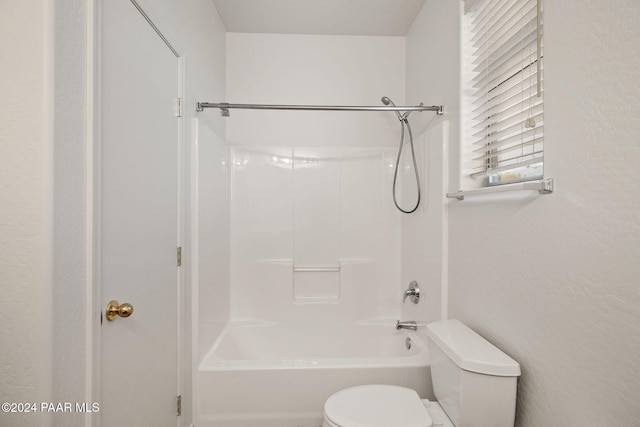 bathroom with shower / washtub combination and toilet