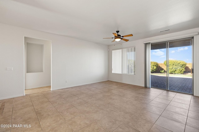 unfurnished room with ceiling fan and light tile patterned flooring