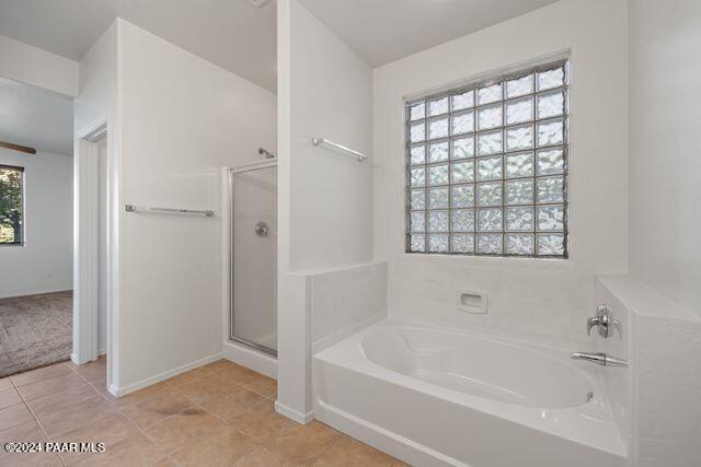 bathroom with tile patterned floors and plus walk in shower