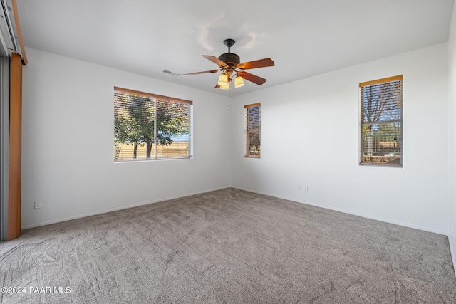 empty room with light colored carpet and ceiling fan