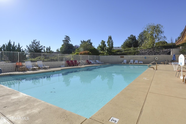 pool featuring a patio and fence