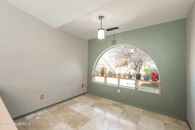 empty room featuring visible vents and baseboards