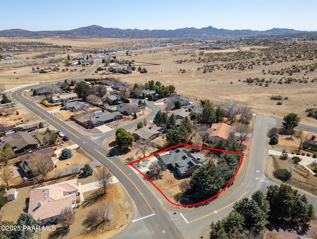 birds eye view of property featuring a mountain view, a residential view, and a desert view