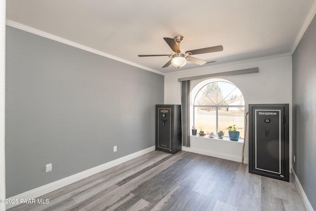 entryway featuring ceiling fan, baseboards, wood finished floors, and crown molding