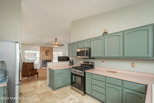 kitchen with green cabinetry and stainless steel appliances