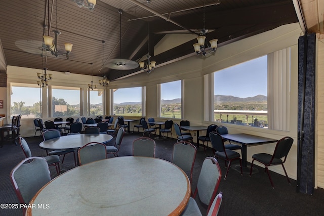 dining space featuring a mountain view and lofted ceiling