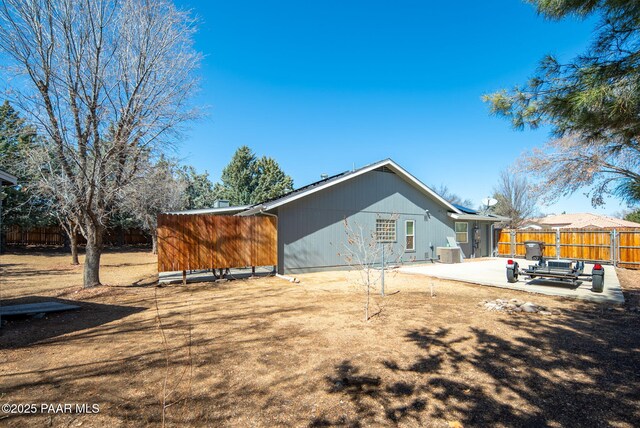 back of house with cooling unit, a patio area, and a fenced backyard