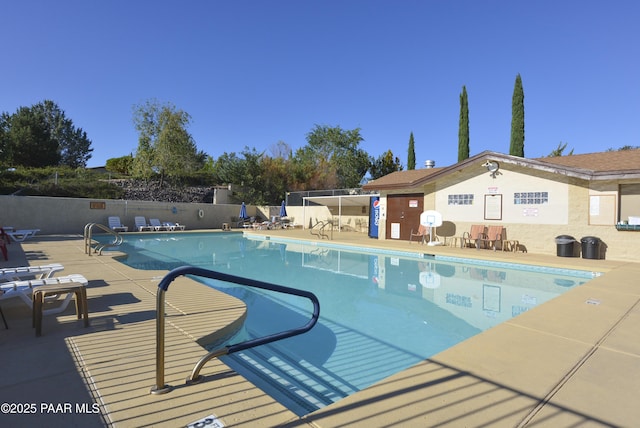 pool featuring a patio area and fence