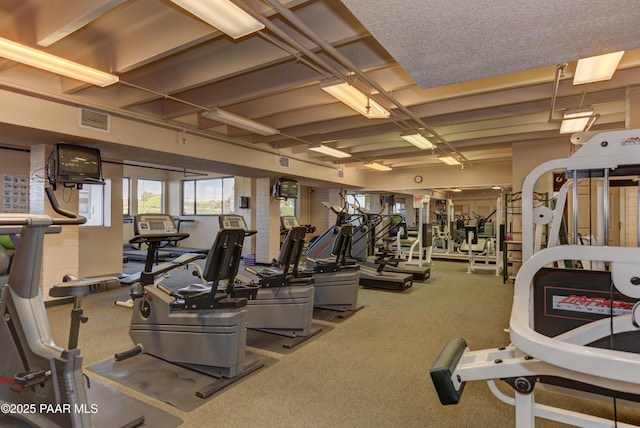 workout area with visible vents and carpet flooring