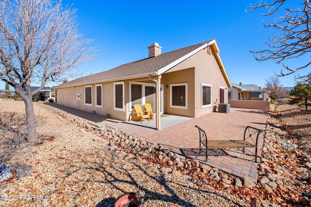 back of property with a patio area and central air condition unit