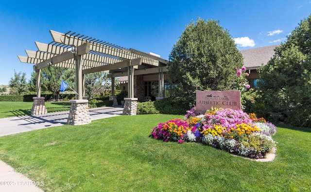 exterior space featuring a pergola and a lawn