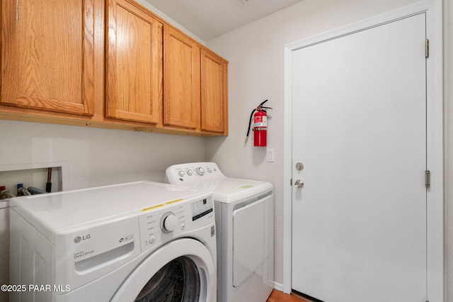 washroom featuring cabinets and washer and dryer