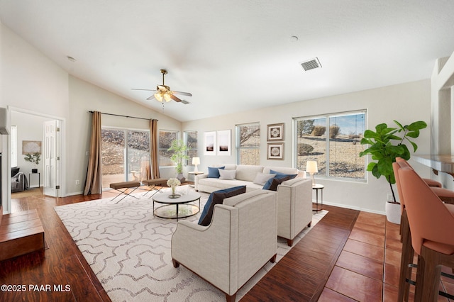 living room featuring hardwood / wood-style flooring, ceiling fan, and vaulted ceiling