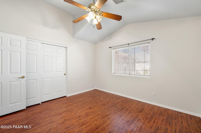 unfurnished bedroom featuring ceiling fan, wood-type flooring, vaulted ceiling, and a closet