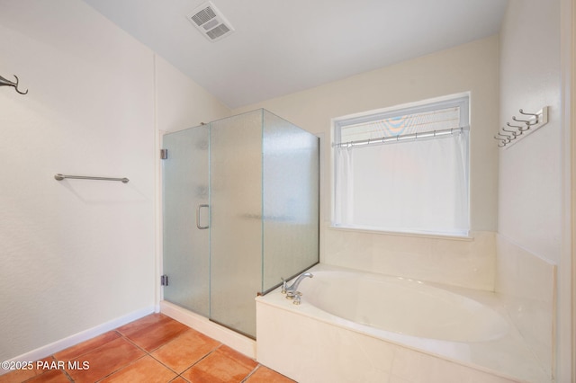 bathroom featuring tile patterned floors and separate shower and tub