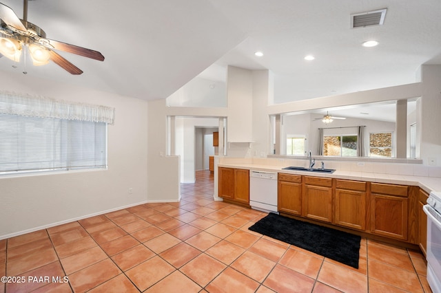 kitchen featuring sink, vaulted ceiling, light tile patterned floors, ceiling fan, and white appliances