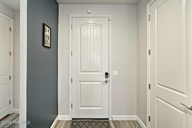 entryway featuring light wood-style flooring and baseboards