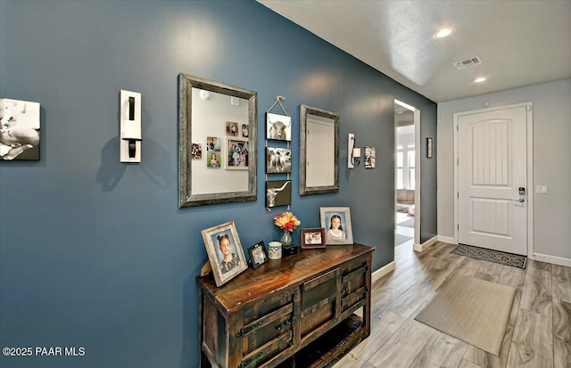 foyer entrance featuring recessed lighting, visible vents, baseboards, and light wood-style flooring