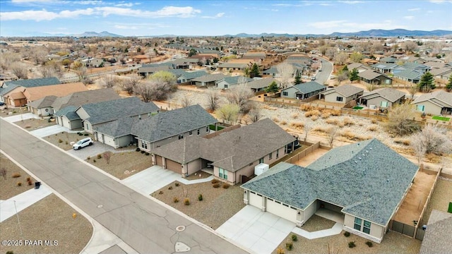 drone / aerial view featuring a residential view and a mountain view