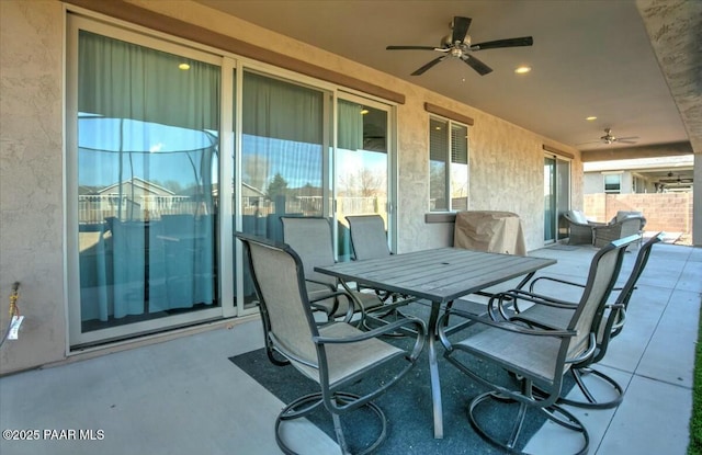 view of patio with outdoor dining area and ceiling fan