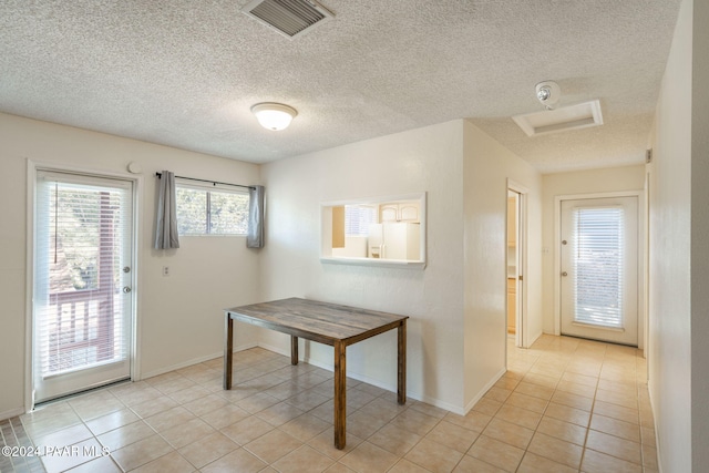 doorway featuring light tile patterned flooring