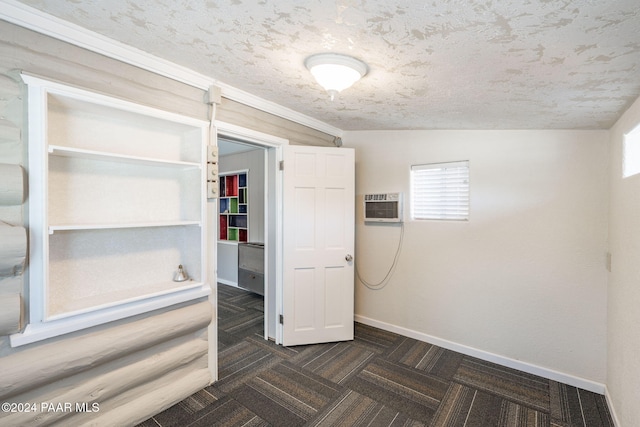 interior space featuring a wall mounted air conditioner and dark parquet flooring