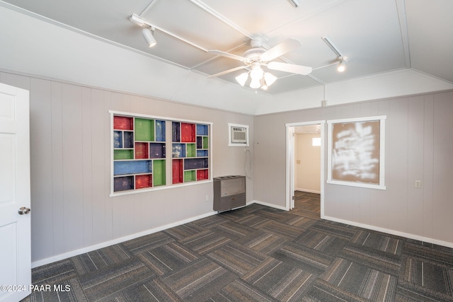 unfurnished room with a wall mounted air conditioner, ceiling fan, and lofted ceiling