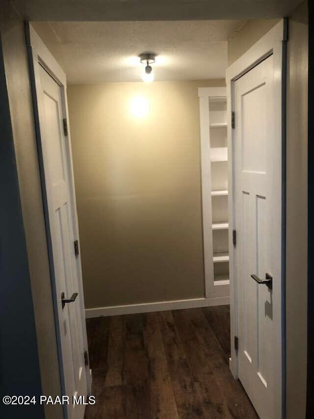 hall with dark hardwood / wood-style flooring