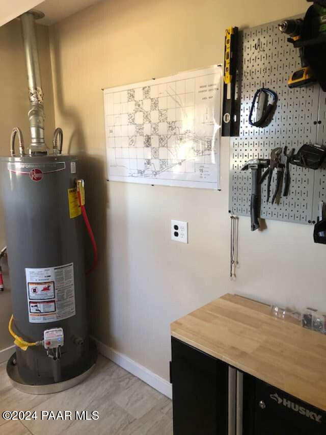 utility room with gas water heater