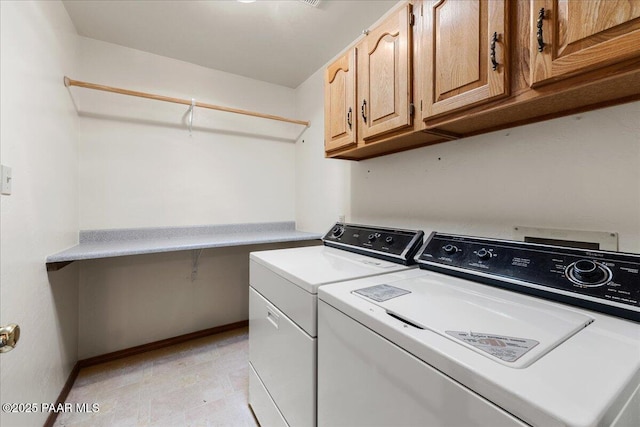 laundry area with cabinets and washer and clothes dryer