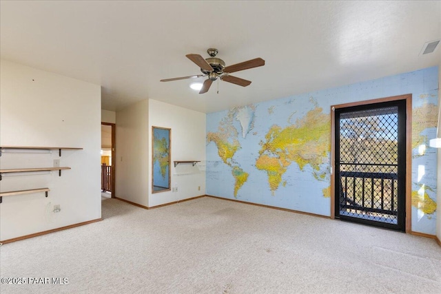 carpeted spare room with ceiling fan