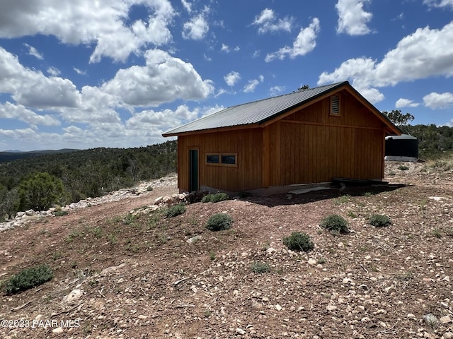 view of home's exterior featuring an outbuilding