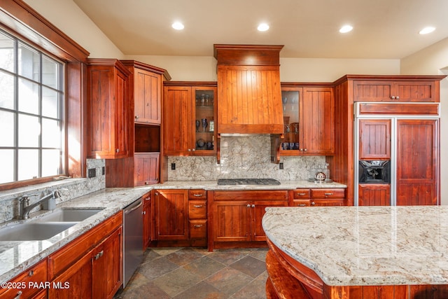 kitchen featuring light stone counters, sink, backsplash, and appliances with stainless steel finishes