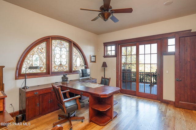 home office featuring light hardwood / wood-style floors and ceiling fan