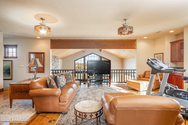 living room featuring vaulted ceiling with beams and light wood-type flooring